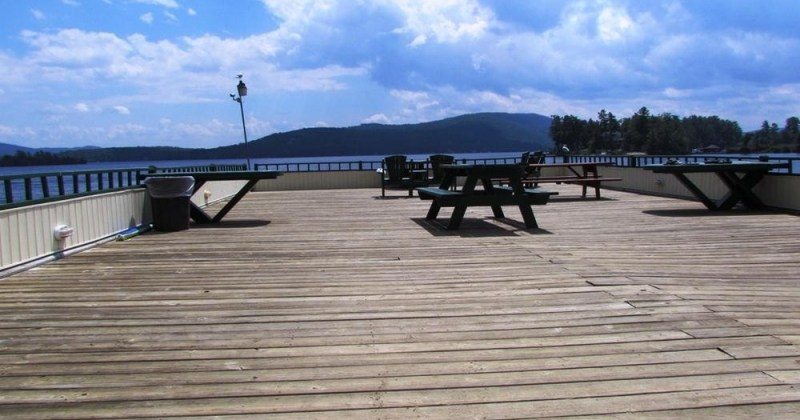 large open deck with picnic tables and Adirondack chairs