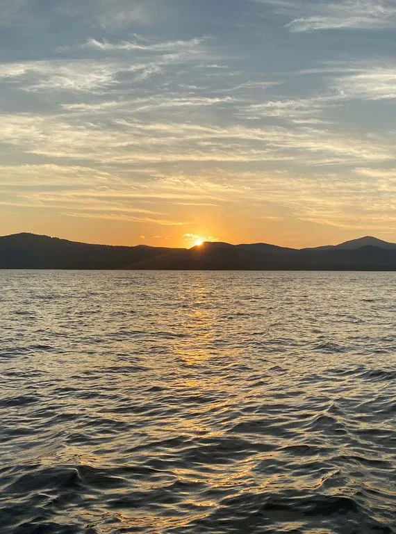 sunset over the mountains past the lake